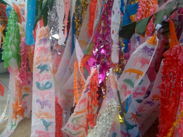 Songkran: A festival celebrating the traditional Thai New Year, held in April, and marked by the throwing and sprinkling of water on young and old. Festive banners marking the months of the Chinese Zodiac, a scheme and systematic plan of future action, that relates each year to an animal and its reputed attributes, according to a 12-year cycle.  IPhone photograph 